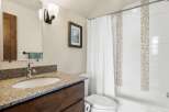 This beautiful bathroom features a modern design with a granite countertop and a stylish sink.
