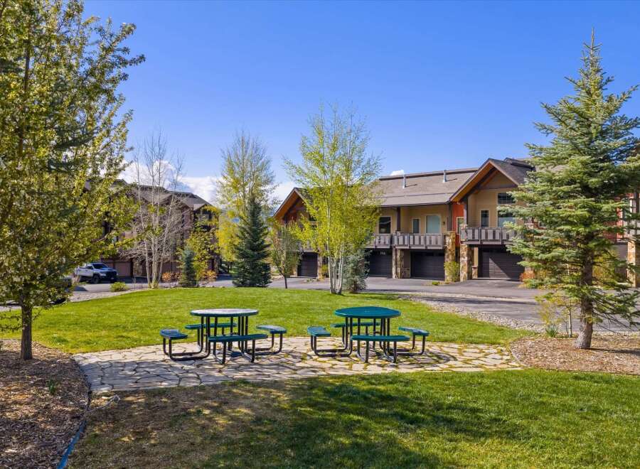 Enjoy the serene beauty of this property, featuring lush green spaces and inviting picnic areas.