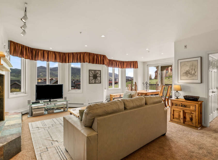 This stunning living room boasts breathtaking mountain views, creating a serene and inviting atmosphere.