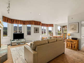 This stunning living room boasts breathtaking mountain views, creating a serene and inviting atmosphere.