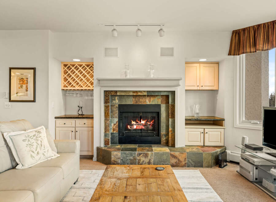 This stunning living room boasts a cozy fireplace, perfect for chilly evenings.