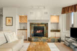 This stunning living room boasts a cozy fireplace, perfect for chilly evenings.