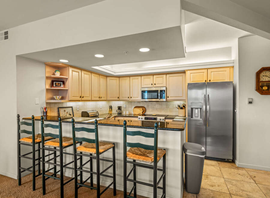 This stunning kitchen boasts a modern design with sleek countertops and ample cabinet space.