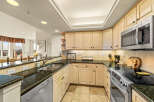 This stunning kitchen boasts elegant granite countertops and ample cabinet space, perfect for culinary enthusiasts.