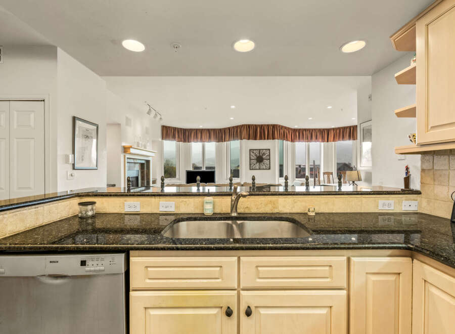 This stunning kitchen boasts a sleek design with granite countertops and stainless steel appliances.