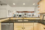 This stunning kitchen boasts a sleek design with granite countertops and stainless steel appliances.