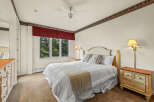 This cozy bedroom features a comfortable bed with plush pillows and a stylish throw blanket.