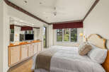 This inviting bedroom boasts a cozy ambiance with its plush bedding and elegant headboard.