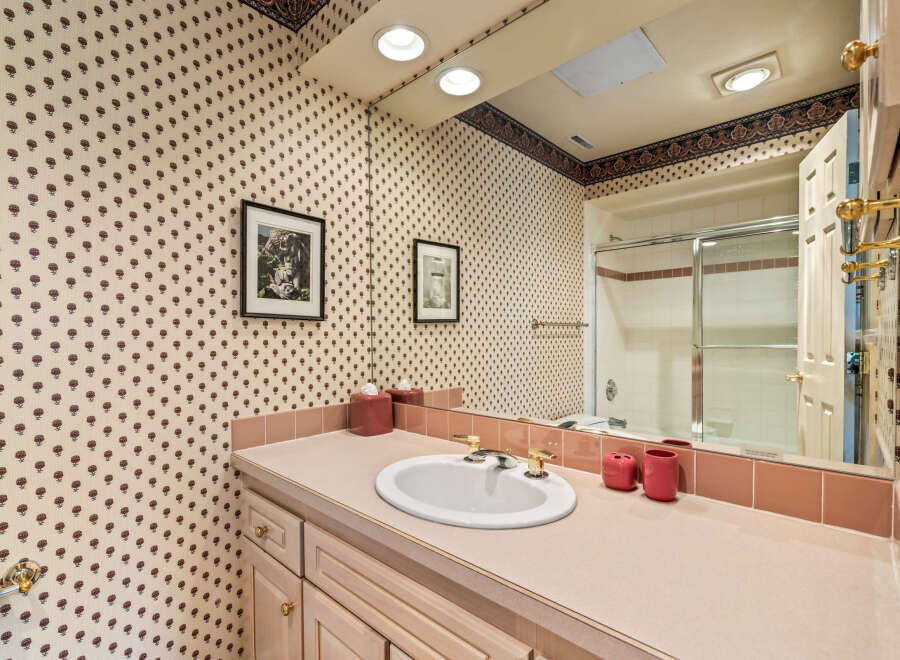 Step into this charming bathroom, featuring a classic design and ample space.