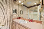 Step into this charming bathroom, featuring a classic design and ample space.