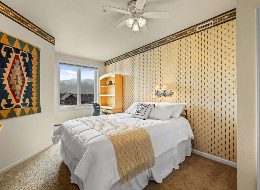 This charming bedroom offers a cozy retreat with its inviting ambiance and stylish decor.