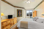This cozy bedroom features a comfortable bed with a stylish throw blanket and decorative pillows.