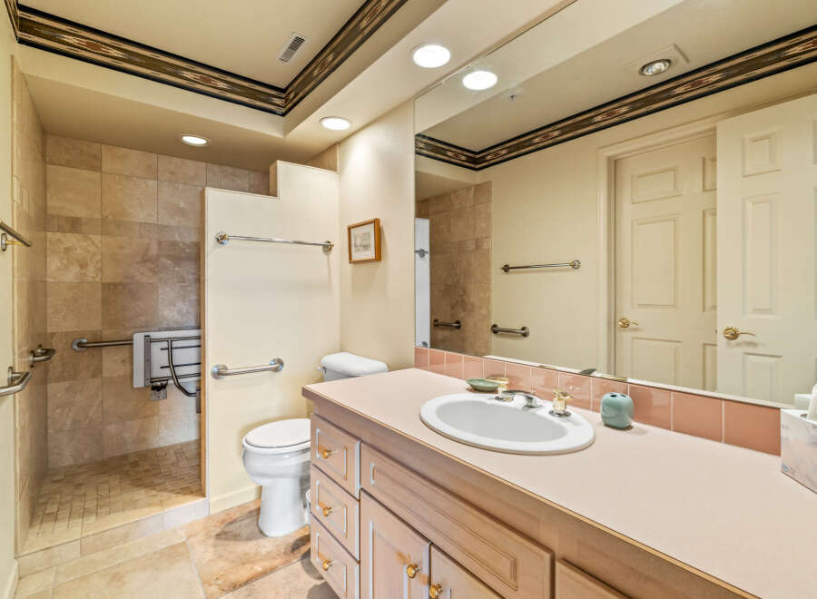 This bathroom features a neutral color palette with a touch of warmth, creating a serene and inviting atmosphere.