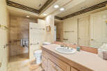 This bathroom features a neutral color palette with a touch of warmth, creating a serene and inviting atmosphere.