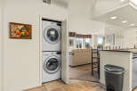 This stunning property boasts a modern laundry area with a stacked washer and dryer, perfect for convenient living.