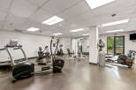 This well-equipped gym offers a variety of exercise machines, including treadmills, elliptical trainers, and stationary bikes, perfect for a comprehensive workout.