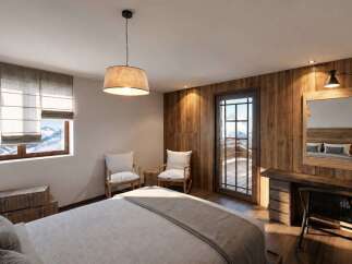 Experience mountain living in this cozy bedroom featuring a comfortable bed, rustic wooden walls, and a stunning view of snow-capped peaks through the large window.