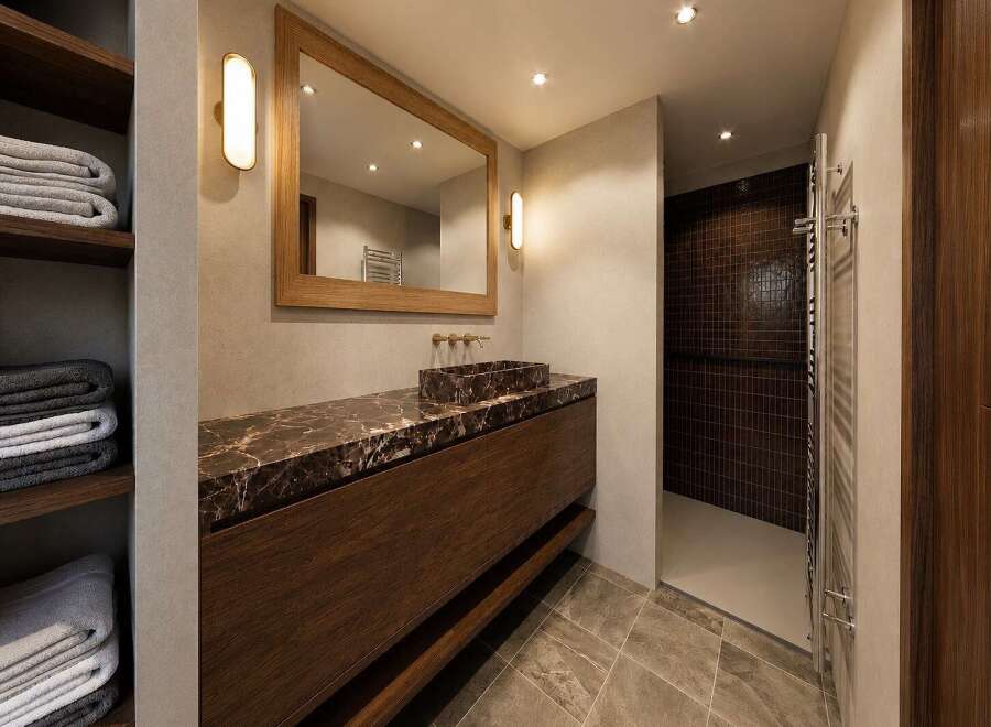 Experience luxury in this modern bathroom featuring a stunning marble vanity with a vessel sink and warm wood cabinetry.