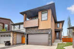 This stunning modern home boasts a striking exterior with a combination of stone and stucco.