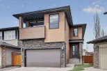 This stunning modern home boasts a striking exterior with a combination of stone, stucco, and wood accents.