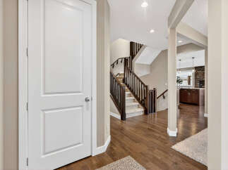Step into this inviting home and be greeted by a stunning staircase and beautiful hardwood floors.