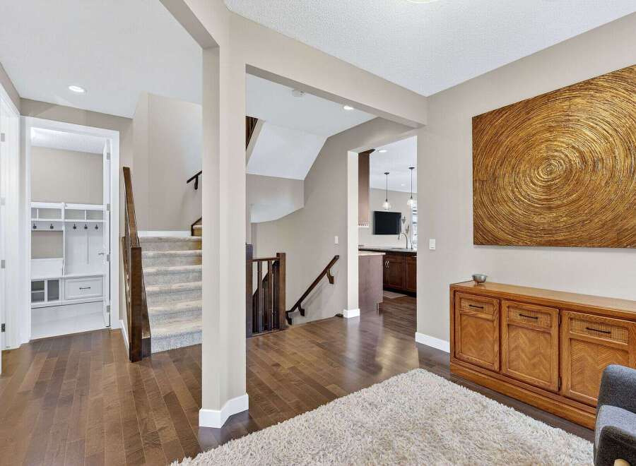 Step into luxury with this stunning home featuring a grand entryway and exquisite hardwood floors.