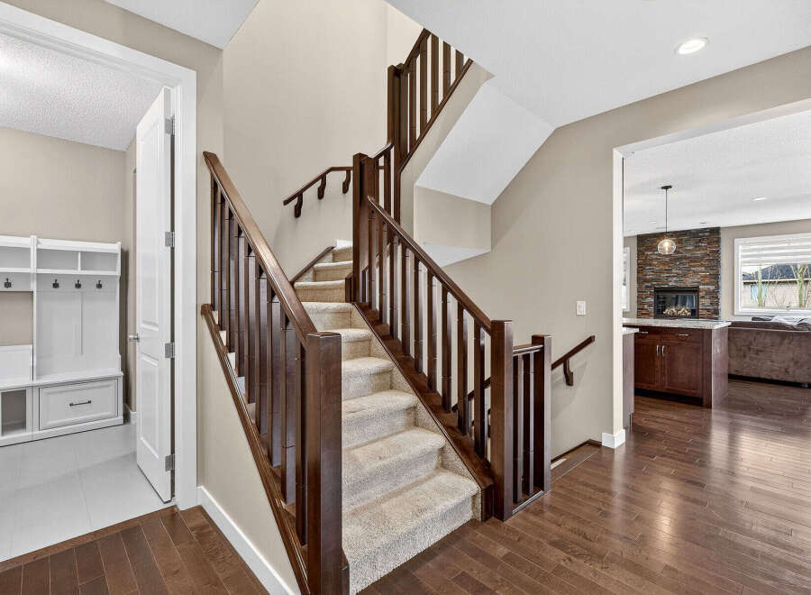 Step into luxury with this stunning home featuring a grand staircase with rich wooden accents.