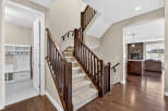 Step into luxury with this stunning home featuring a grand staircase with rich wooden accents.