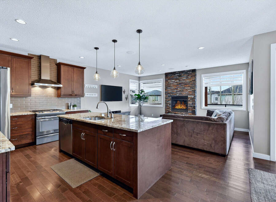 This stunning kitchen and living area boasts a modern design with high-end finishes.