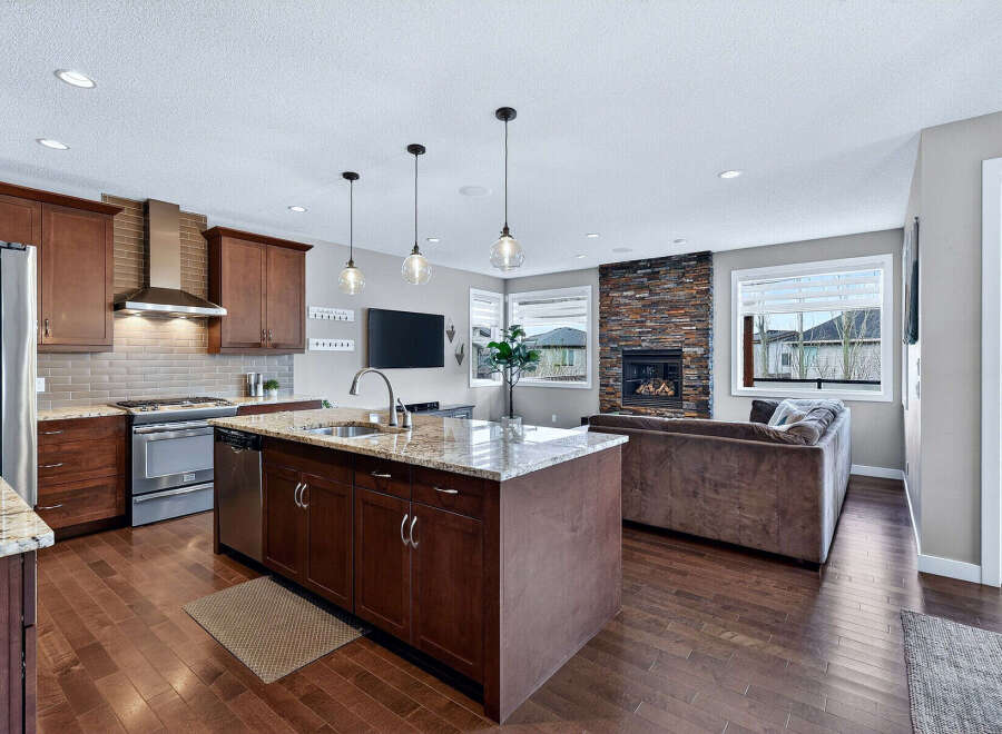 This stunning kitchen and living area boasts a modern design with high-end finishes.