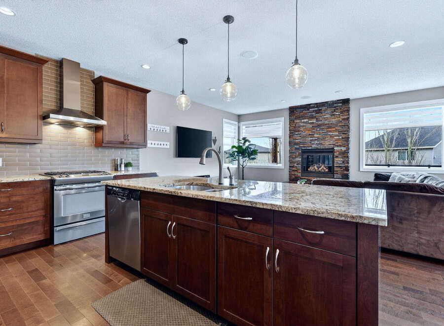 This stunning kitchen boasts a modern design with rich, dark cabinetry and a spacious island, perfect for both cooking and entertaining.