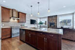 This stunning kitchen boasts a modern design with rich, dark cabinetry and a spacious island, perfect for both cooking and entertaining.