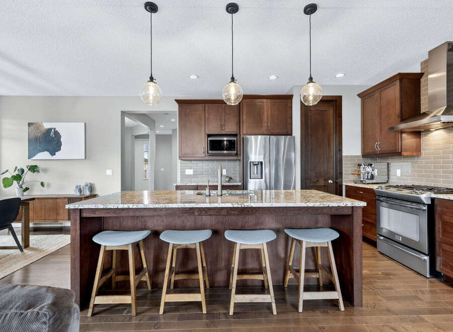 This stunning kitchen boasts a spacious island with seating, perfect for entertaining or casual dining.