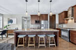 This stunning kitchen boasts a spacious island with seating, perfect for entertaining or casual dining.