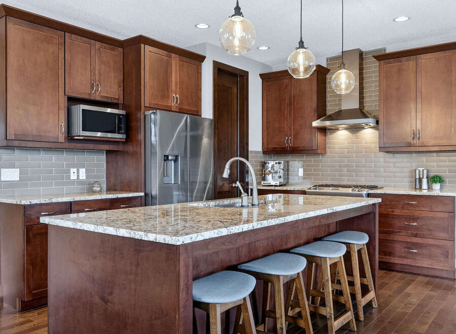This stunning kitchen boasts rich, dark wood cabinetry and a spacious island, perfect for both cooking and entertaining.
