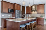 This stunning kitchen boasts rich, dark wood cabinetry and a spacious island, perfect for both cooking and entertaining.