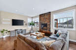 Step into luxury with this stunning living room, featuring a cozy fireplace and a spacious, comfortable sofa.