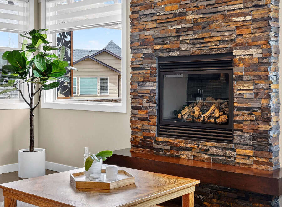 This stunning property boasts a cozy fireplace with a beautiful stone surround, perfect for those chilly evenings.