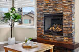 This stunning property boasts a cozy fireplace with a beautiful stone surround, perfect for those chilly evenings.