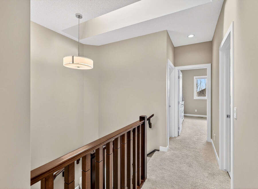 This stunning property features a beautifully designed hallway with a warm and inviting atmosphere.
