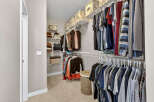 Step into the organized elegance of this walk-in closet, a perfect feature for any home.