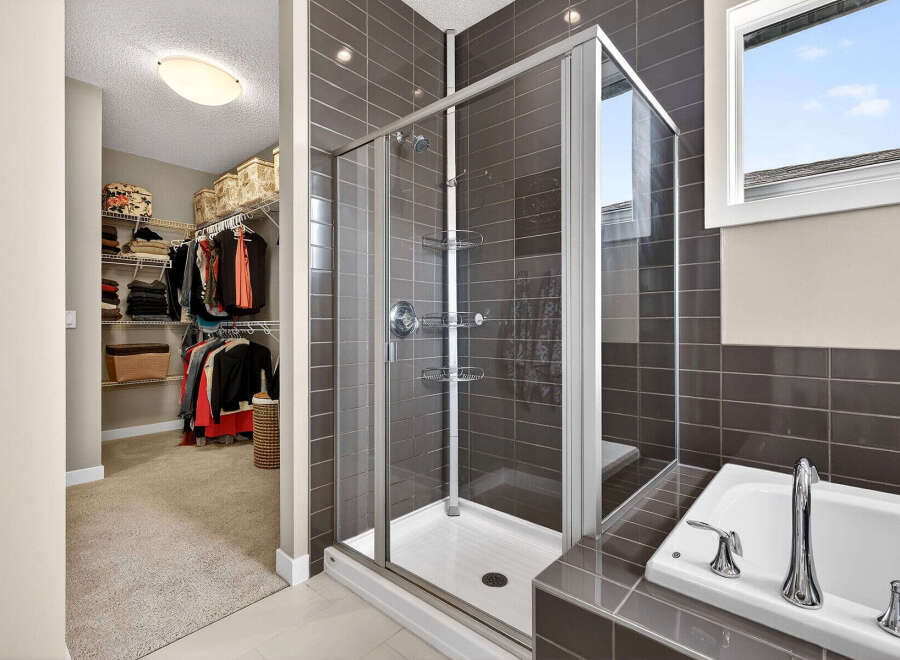 Step into luxury with this stunning bathroom featuring a modern glass shower and elegant tile work.