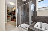Step into luxury with this stunning bathroom featuring a modern glass shower and elegant tile work.