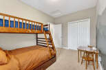 This charming bedroom features a cozy bunk bed, perfect for kids or guests.