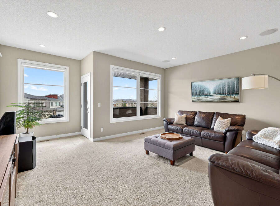 Step into luxury with this stunning living room! Featuring a cozy leather sofa, a stylish ottoman, and a beautiful painting, this space is perfect for relaxation and entertaining.