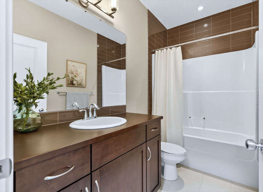 Step into this beautifully designed bathroom, featuring a sleek vanity with ample storage and a stylish sink.