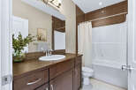 Step into this beautifully designed bathroom, featuring a sleek vanity with ample storage and a stylish sink.