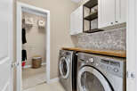 Step into this beautifully designed laundry room, featuring modern appliances and ample storage.