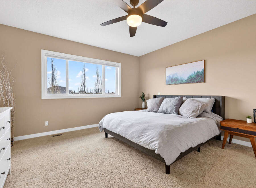 Step into this inviting bedroom, featuring a cozy ambiance and modern design.