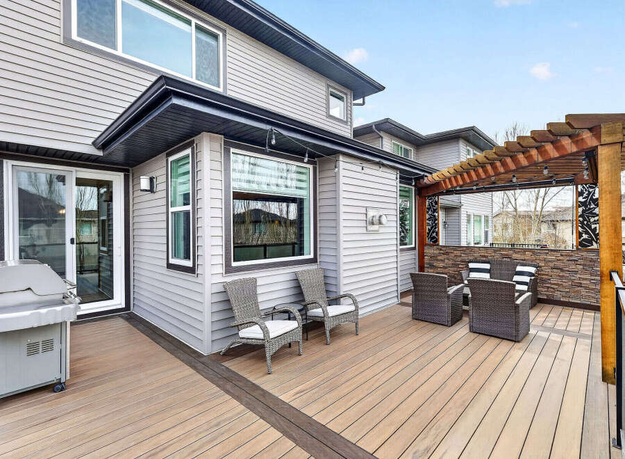 Enjoy outdoor living at its finest with this stunning property featuring a spacious deck and a cozy pergola.